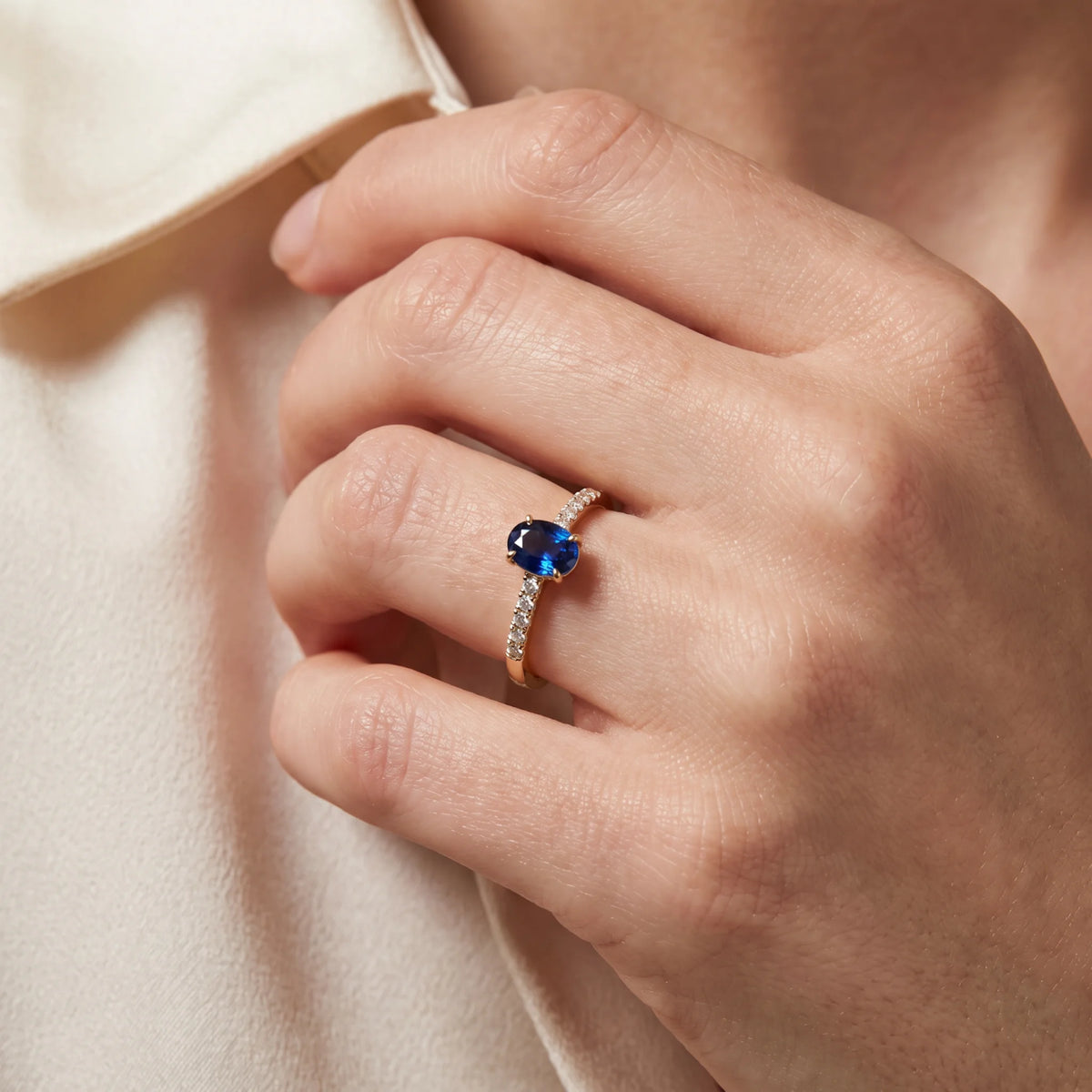 Ring in 585er Gelbgold mit Diamant &amp; Saphir, an der Hand getragen (KI-generiert)
